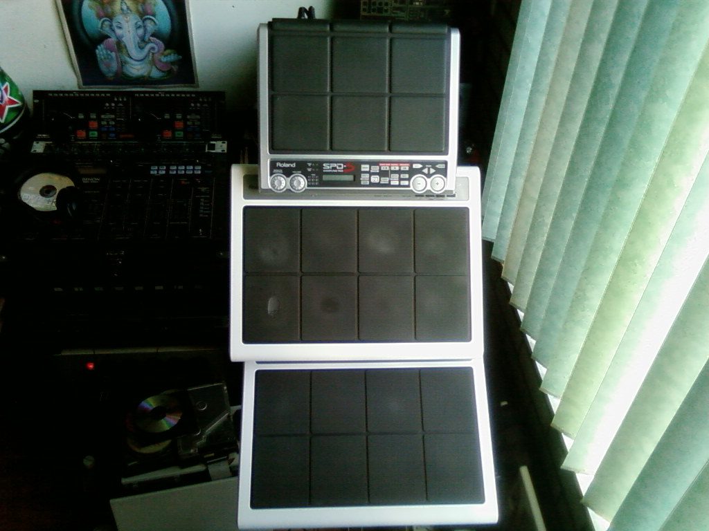 Two Roland SPD-20 pads and an SPD-S stacked together in a home studio